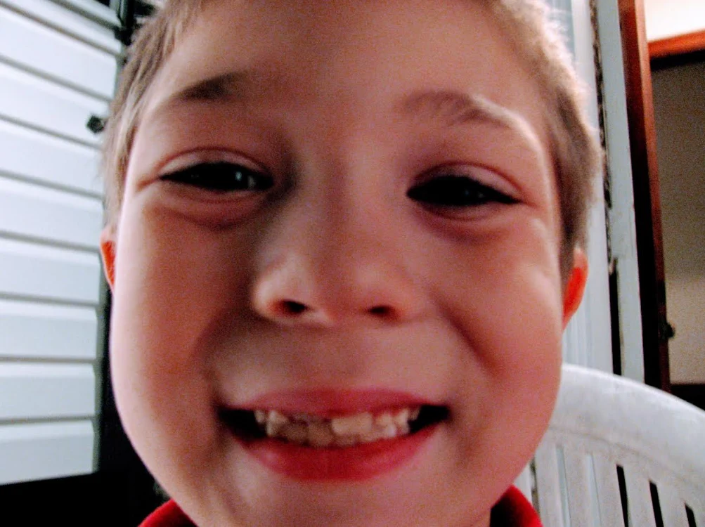 A candid childhood close-up of Shayne smiling.